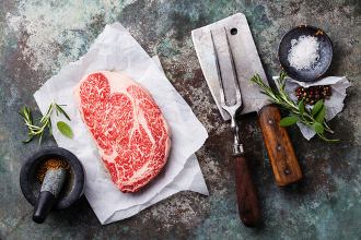 Raw fresh marbled meat Black Angus Steak Ribeye and seasonings on metal background